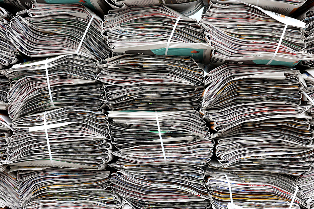 Bundles of printed newspapers stacked for distribution.