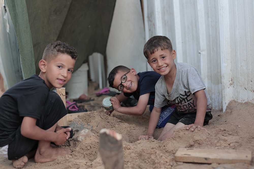 Three Gaza Boys playing in the sand