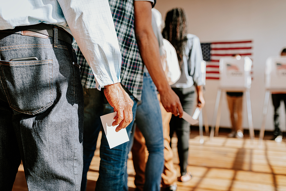 People standing in line as they wait to vote.