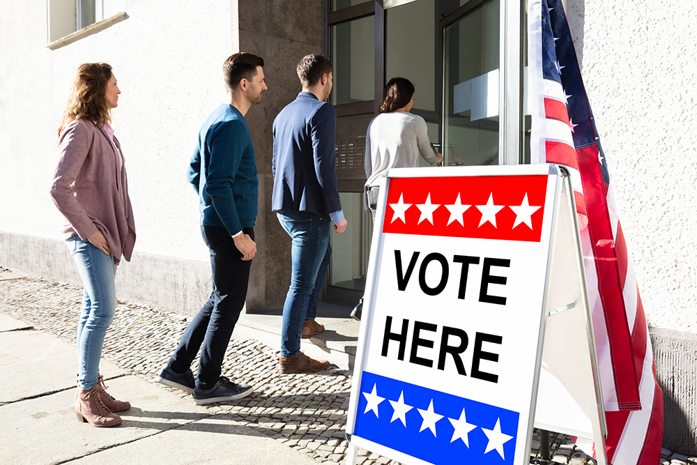 People standing in line as they wait to vote.